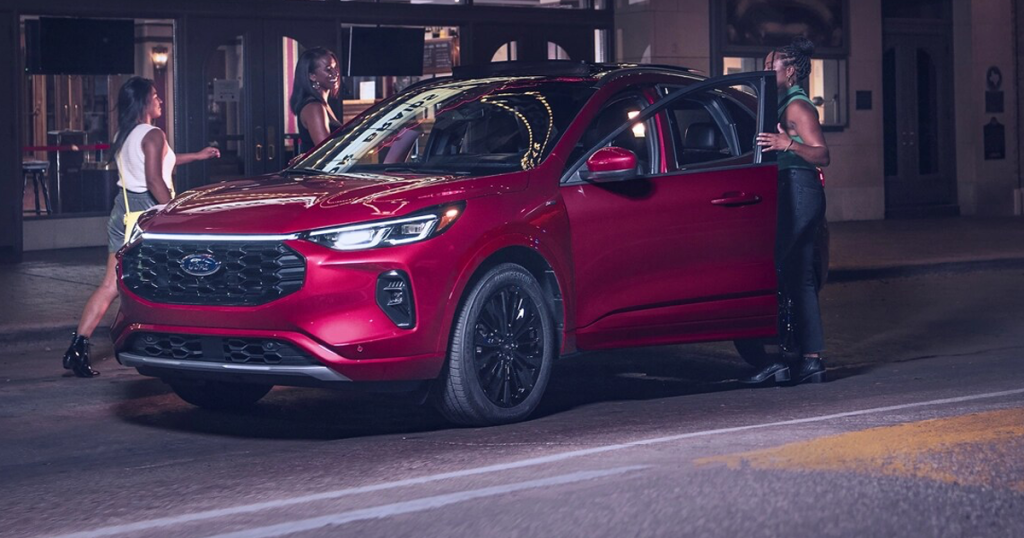 A group of friends getting into a Ford Escape parked on the street