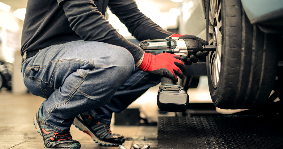 Ford technician installing a tire